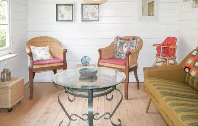 a living room with chairs and a glass table at Awesome Home In Spøttrup With Wifi in Spottrup