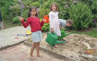 two little girls playing in a sandbox with a boy at Awesome Home In Spøttrup With Wifi in Spottrup