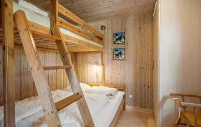 a bunk bed with a ladder in a room at Holiday Home Sommerstedvej Denm in Vinderup
