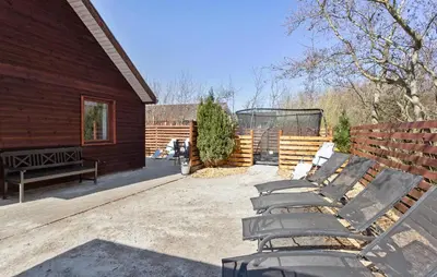 a group of benches sitting outside of a building at Amazing Home In Vinderup With Sauna in Vinderup