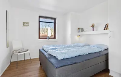 a bedroom with a large bed with blue sheets at Amazing Home In Vinderup With Sauna in Vinderup