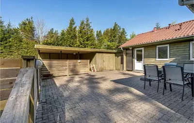 a patio with chairs in front of a house at Holiday Home Skibstedvej Hurup Thy in Sønder Ydby