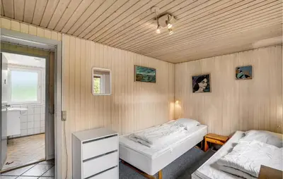 a bedroom with two beds and a bathroom at Holiday Home Skibstedvej Hurup Thy in Sønder Ydby