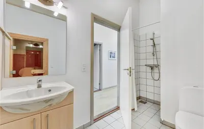 a white bathroom with a sink and a mirror at Holiday Home Kildebakken Vinderup V in Vinderup