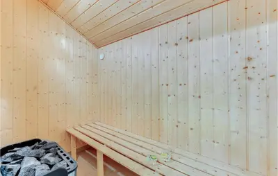 a wooden room with a bench in the corner at Holiday Home Kildebakken Vinderup V in Vinderup