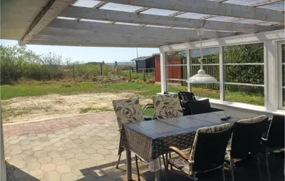 a patio with a table and chairs on a patio at Holiday Home Lærkevej Vinderup Xii in Vinderup
