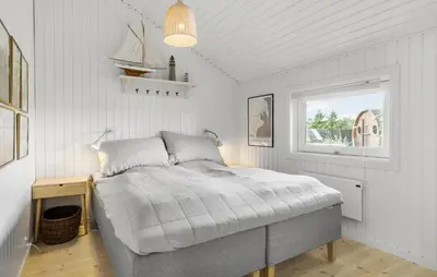 a bedroom with a bed in a room with a window at Holiday Home Ballesvej in Øster Assels