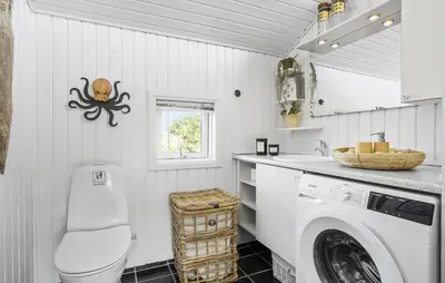 a white laundry room with a washer and dryer at Holiday Home Ballesvej in Øster Assels