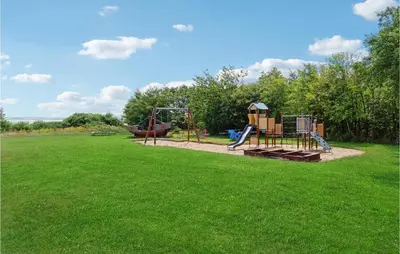 a park with a playground with a swing at Holiday Home Limfjordsvangen Snedsted X in Snedsted