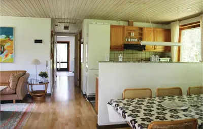 a kitchen and a living room with a dining room table at Holiday Home Kraghøjvej Nykøbing M Ix in Hesselbjerg