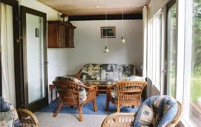 a screened in porch with a table and chairs at Holiday Home Kraghøjvej Nykøbing M Ix in Hesselbjerg
