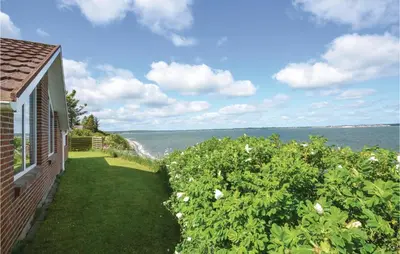 a view of the ocean from a house at Holiday Home Grynderup Strand Roslev in Roslev