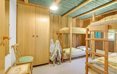 a bedroom with bunk beds and a room with a desk at Holiday Home Sølvmågevej Hurup Thy Ii in Sindrup