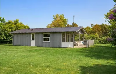 a small gray house with a large yard at Holiday Home Sølvmågevej Hurup Thy Ii in Sindrup