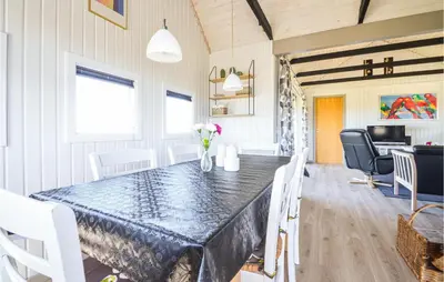 a dining room with a table and chairs at Nice Home In Thisted With Kitchen in Thisted
