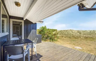 a porch with a table and chairs on a house at Nice Home In Thisted With Kitchen in Thisted