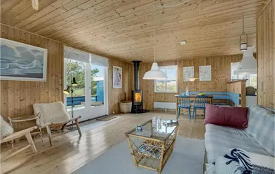 a living room with a couch and a table at Holiday Home Svenstibakkevej Ii in Frøstrup