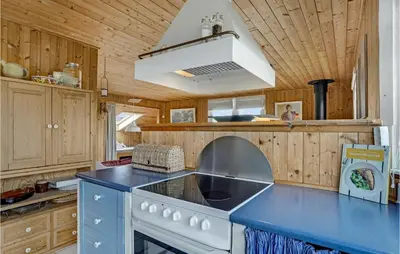 a kitchen with a stove and a blue counter top at Holiday Home Svenstibakkevej Ii in Frøstrup