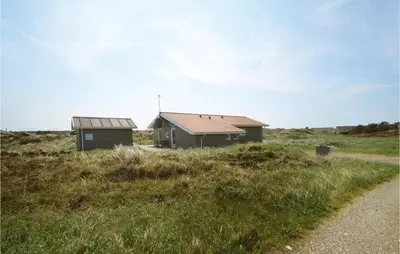 a house in the middle of a grassy field at Holiday Home Svenstibakkevej I in Frøstrup