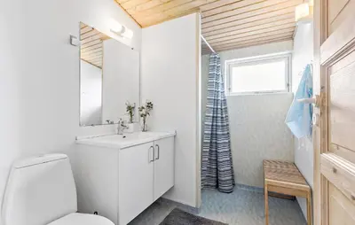 a bathroom with a white toilet and a sink at Gorgeous Home In Thisted With Sauna in Thisted