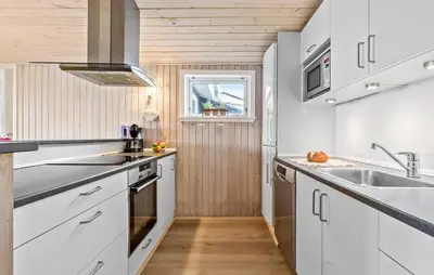 a kitchen with white cabinets and a sink at Gorgeous Home In Thisted With Sauna in Thisted