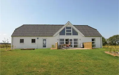 a white house with a large yard at Holiday Home Glombak in Vesløs