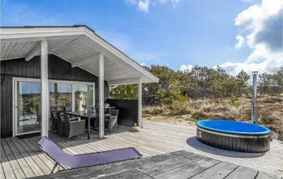a patio with a table and a tub on a deck at Holiday Home Johnsvej Thisted V in Thisted