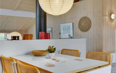 a dining room with a white table and chairs at Holiday Home Kløvborgsti Thisted Ix in Thisted