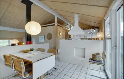 a kitchen and dining room with a table and chairs at Holiday Home Kløvborgsti Thisted Ix in Thisted