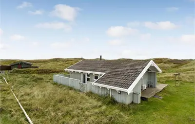 a small white house in a field of grass at Holiday Home Kløvborgsti Thisted Ix in Thisted