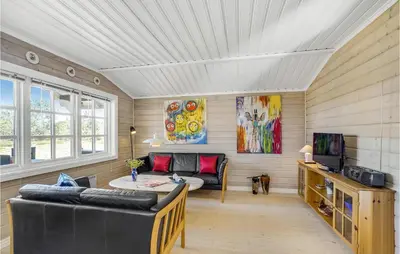 a living room with a couch and a table at Holiday Home Venøvej Højslev Denm in Højslev