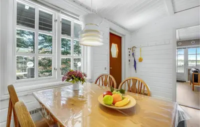 a dining room with a table with a bowl of fruit on it at Holiday Home Venøvej Højslev Denm in Højslev