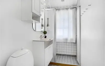 a white bathroom with a shower and a sink at Holiday Home Venøvej Højslev Denm in Højslev