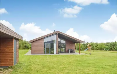 a house with a large window and a grass field at Holiday Home Bronzehøjen Højslev in Højslev