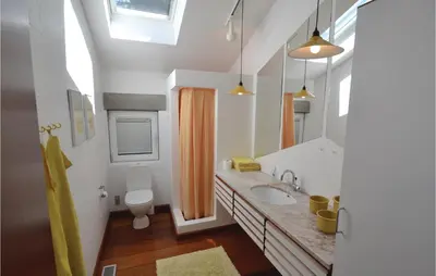 a bathroom with a sink and a toilet at Holiday Home Hesselvej in Farsø
