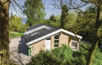 a house with a solar roof on top of it at Holiday Home Hesselvej in Farsø