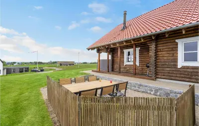 a wooden fence in front of a house at Holiday Home Husvej in Fur