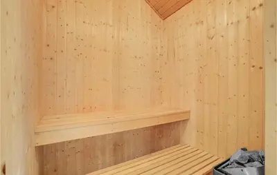 a wooden sauna with a wooden shelf in it at Holiday Home Marthasvej in Løgstør