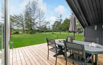 a patio with a table and chairs on a deck at Holiday Home Agathesvej Løgstør V in Løgstør