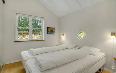 a white room with a large white bed in it at Holiday Home Furvej in Vesløs