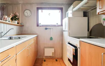 a small kitchen with a sink and a window at Holiday Home Hellesvej Løgstør Xi in Løgstør