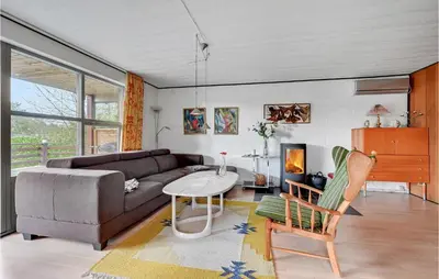 a living room with a couch and a table at Holiday Home Eskovvej in Roslev