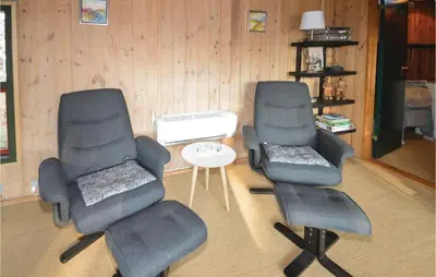 two chairs and a table in a room at Holiday Home N C Alstedsvej Fjerritslev Xii in Fjerritslev