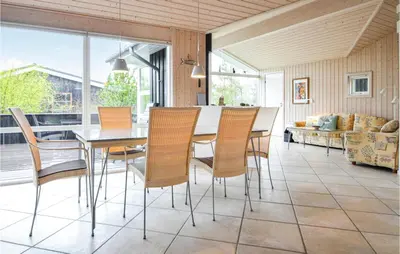 a dining room with a table and chairs at Holiday Home Revlingestien Fjerritslev Iv in Fjerritslev