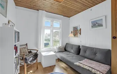 a living room with a couch and a window at Holiday Home Svenstibakkevej Denm in Frøstrup