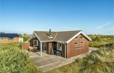 a house on a wooden deck in a field at Holiday Home Svenstibakkevej Denmark I in Frøstrup