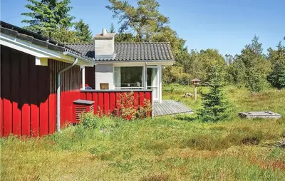 a red and white house in the middle of a field at Holiday Home Revlingestien Fjerritslev Denm in Fjerritslev