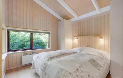 a bedroom with a bed in a room with a window at Holiday Home Rønnevej Fjerritslev Ix in Fjerritslev