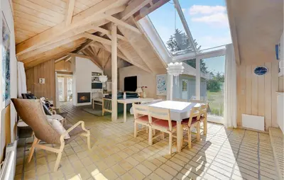 a dining room with a table and chairs in a room at Holiday Home Tulipanvej Fjerritslev I in Fjerritslev