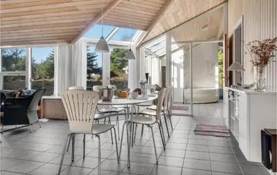 a kitchen and dining room with a table and chairs at 4 Bedroom Gorgeous Home In Fjerritslev in Fjerritslev